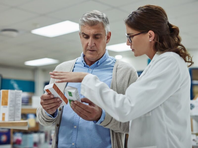 Newer Rheumatoid Arthritis Drug Might Raise Heart, Cancer Risks 7 1800 man talking to pharmacist