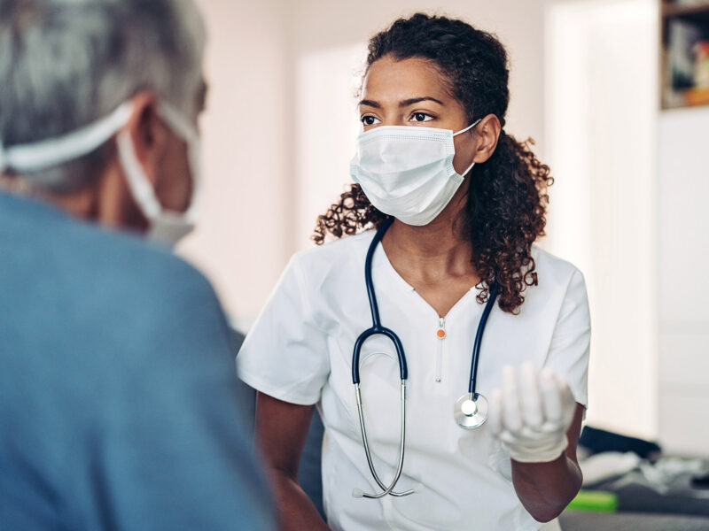 1800x1200 doctor talking with patient covid 19 other