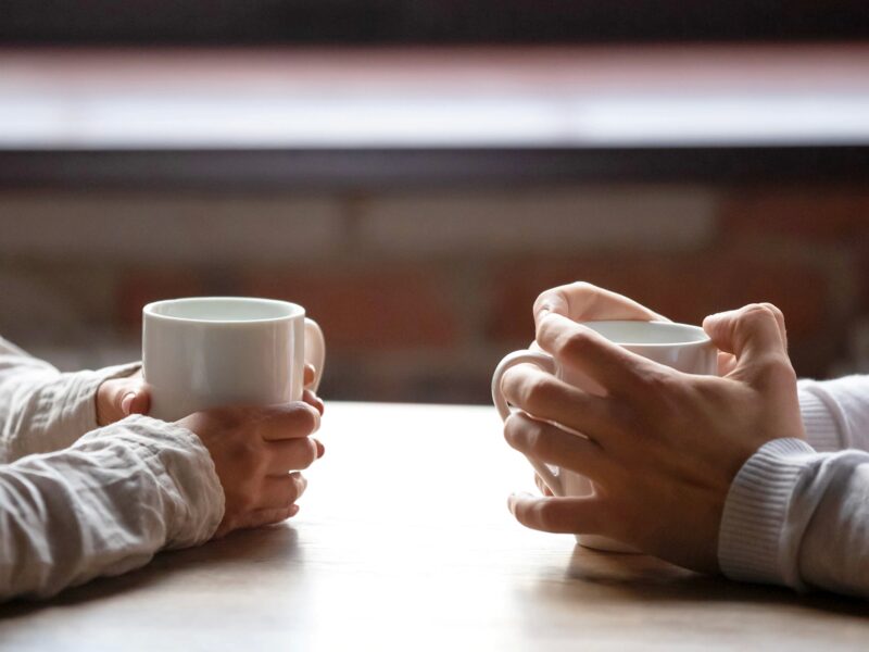 Delta COVID Variant May Increase Risk of Dating, Expert Says 2 1800x1200 hands holding cups of coffee in cafe
