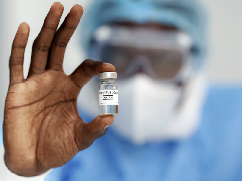 1800x1200 man holding coronavirus vaccine