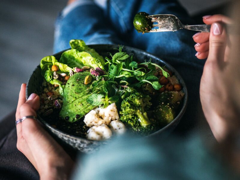 1800x1200 woman eating vegetable bowl with hummus